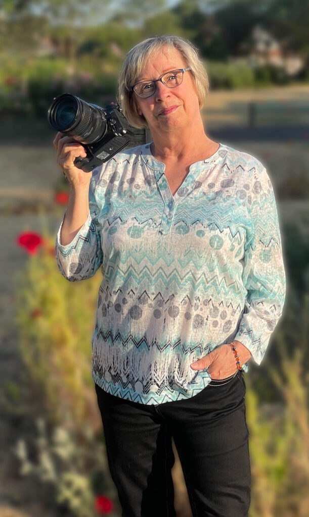 Elaine Cook in her local park on a sunny morning with her camera in her hand