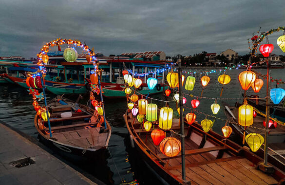 Lighted boats adorned with lanterns on the riverfront at Hoi An, Vietnam