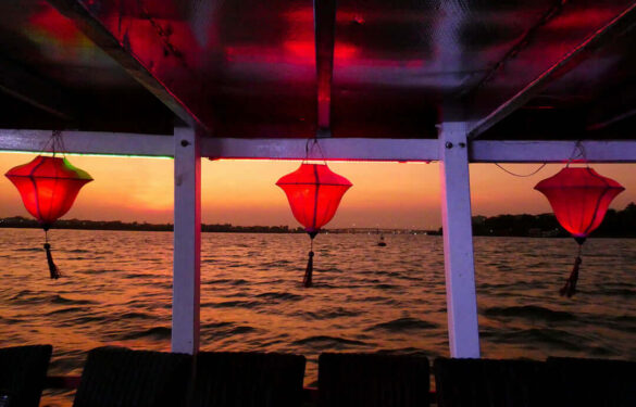 Red lanterns on a river boat during sunset in Hoi An, Vietnam