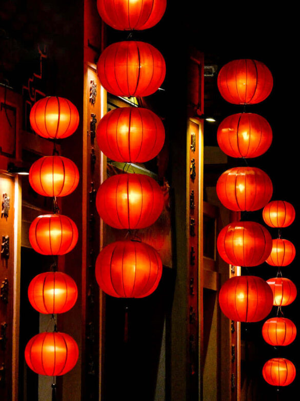 Warm orange lanterns hanging outside a restaurant in Hoi An, Vietnam