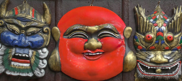 Colorful wall plaques depicting cultural masks in Saigon