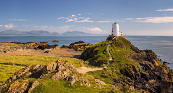 Scenic view of Twr Mawr Lighthouse on a rocky promontory.